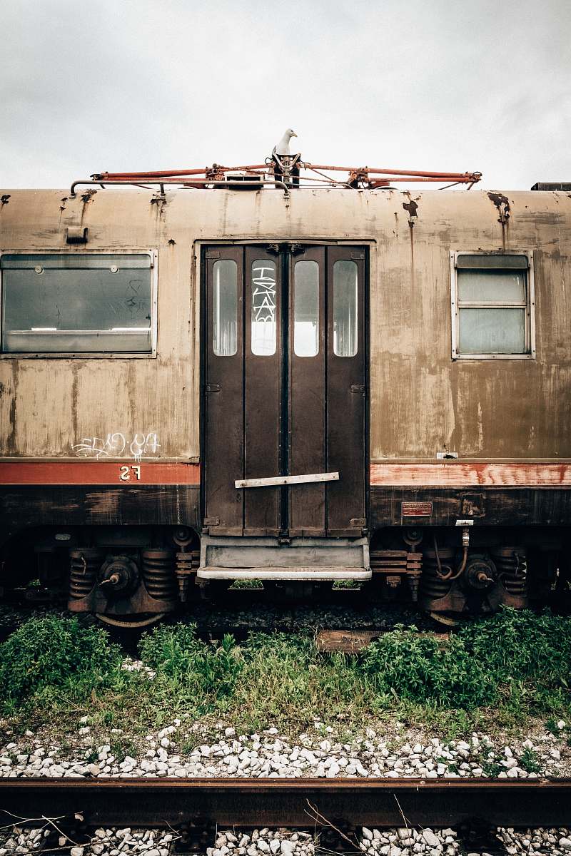 passenger car brown and black abandoned train on rail during daytime trieste